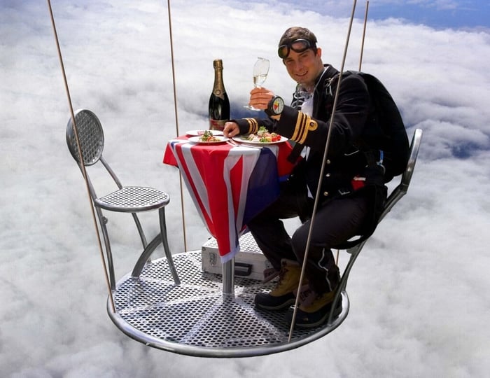 Bear Grylls toasting at 25,000 feet. Image Credit: BearGrylls.com